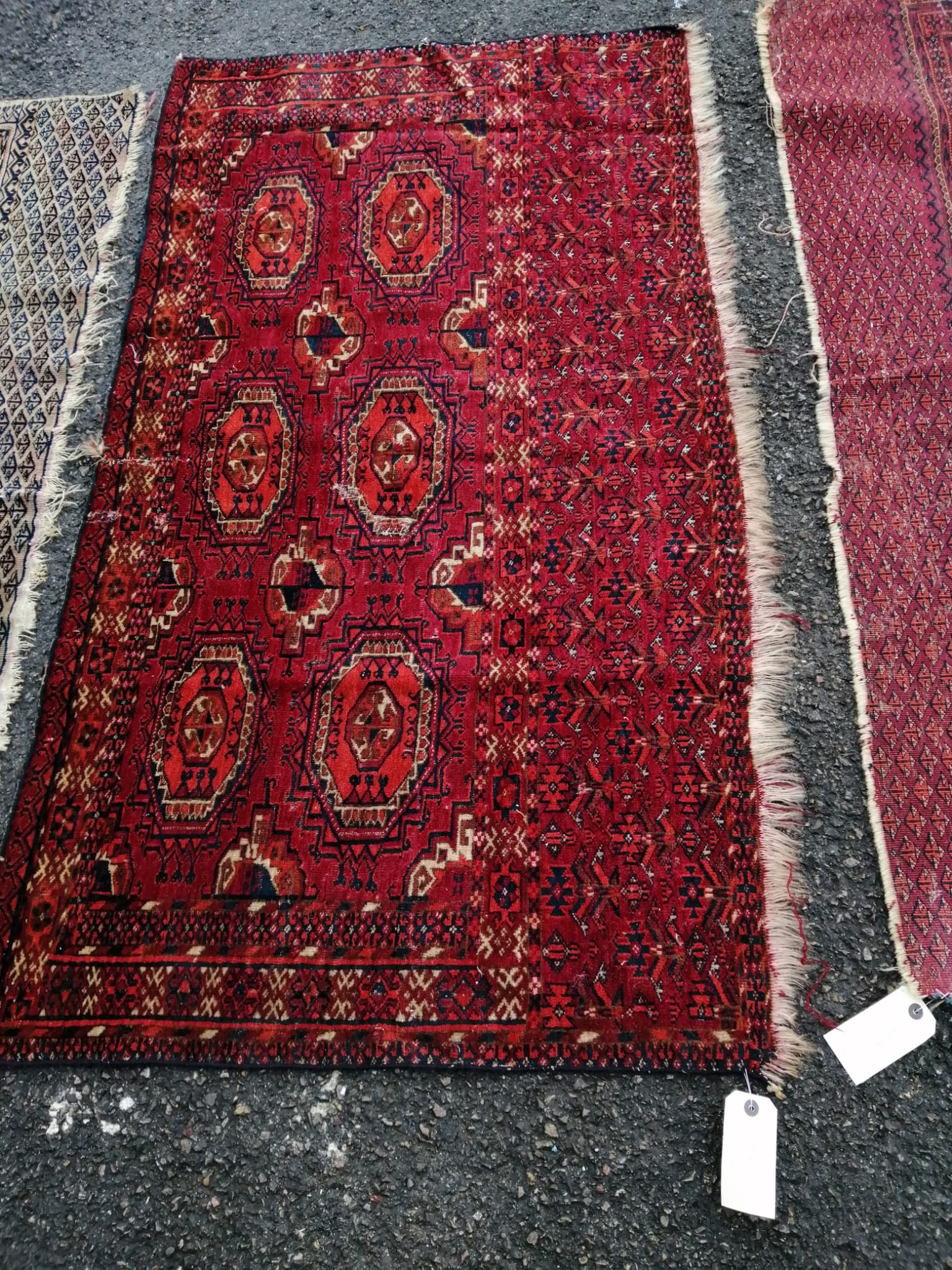 Three antique Salor mats, largest 140 x 82cm